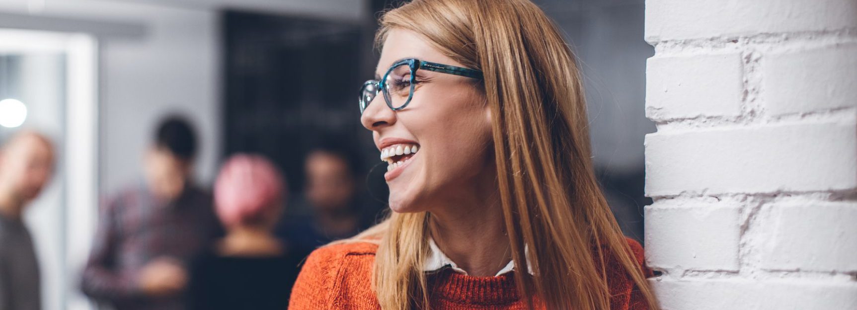 Intraservice employee standing in front of group of colleagues to evaluate their sales marketing and communications